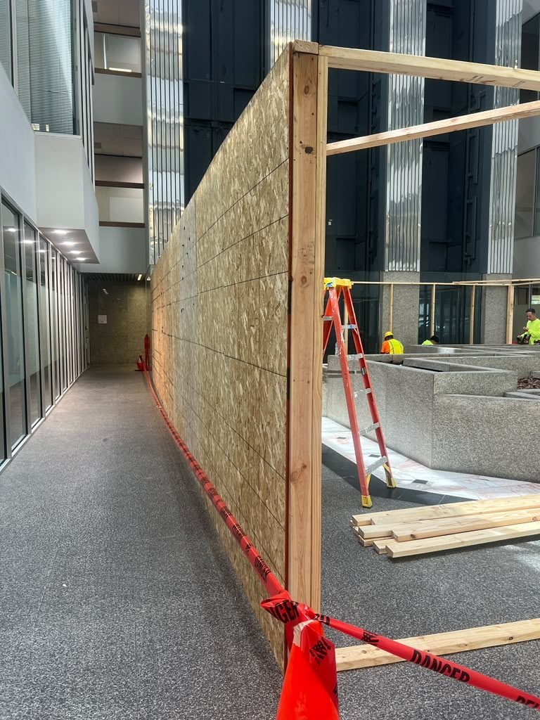 Commercial interior build-out mid-construction with exposed OSB framing
