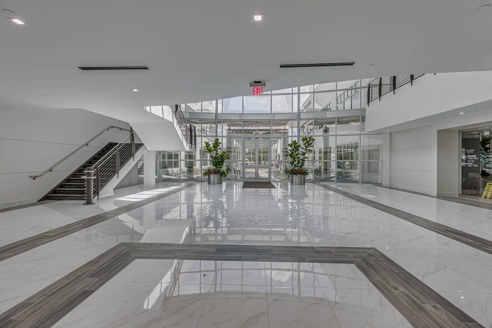 Medical office building lobby with marble flooring and staircase