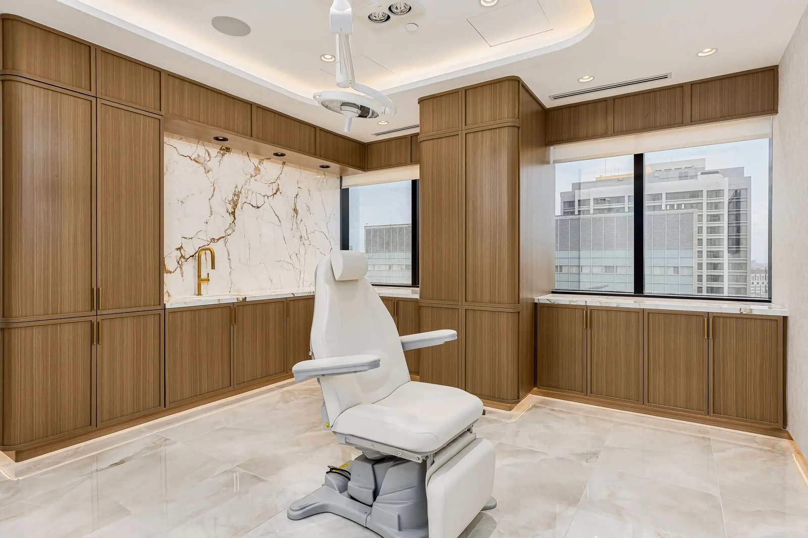 Plastic surgery procedure room with marble and custom cabinetry