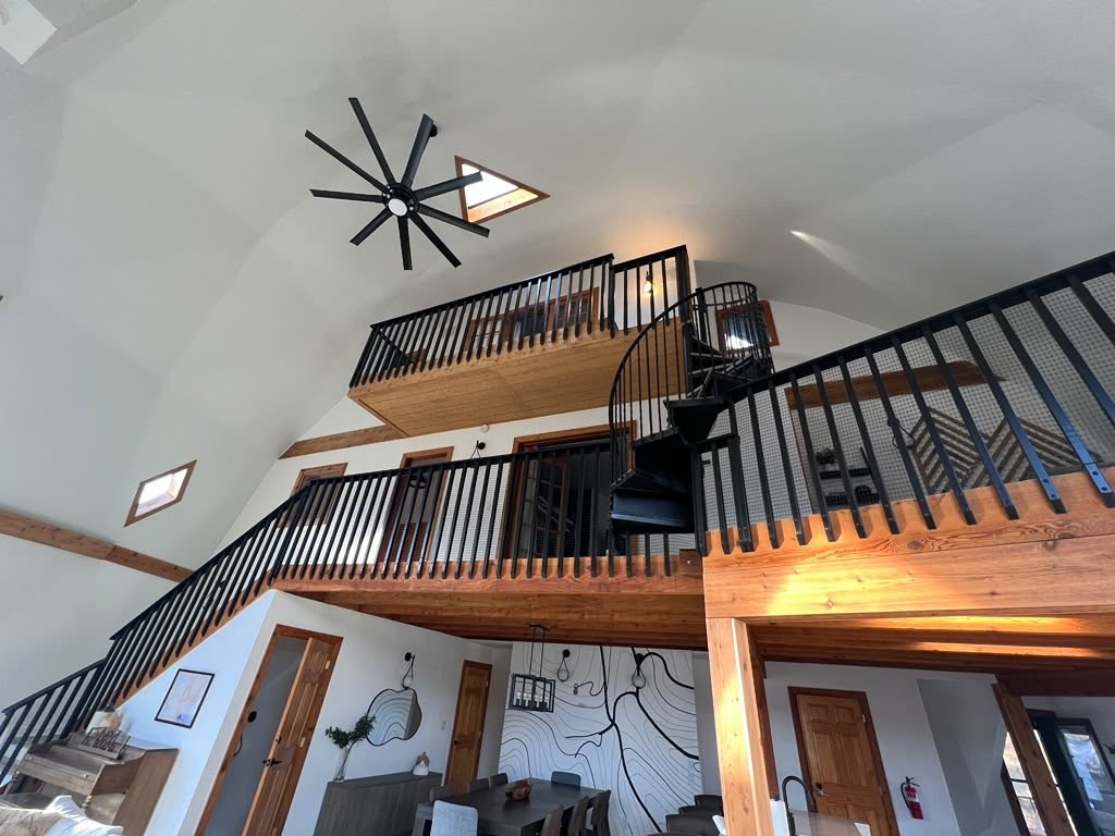 Custom residential interior with open staircase and vaulted ceiling