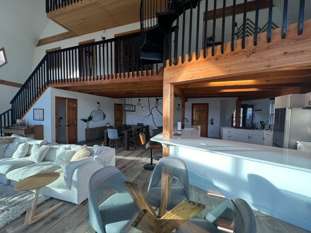 Vaulted great room with exposed wood beams in a completed residential remodel
